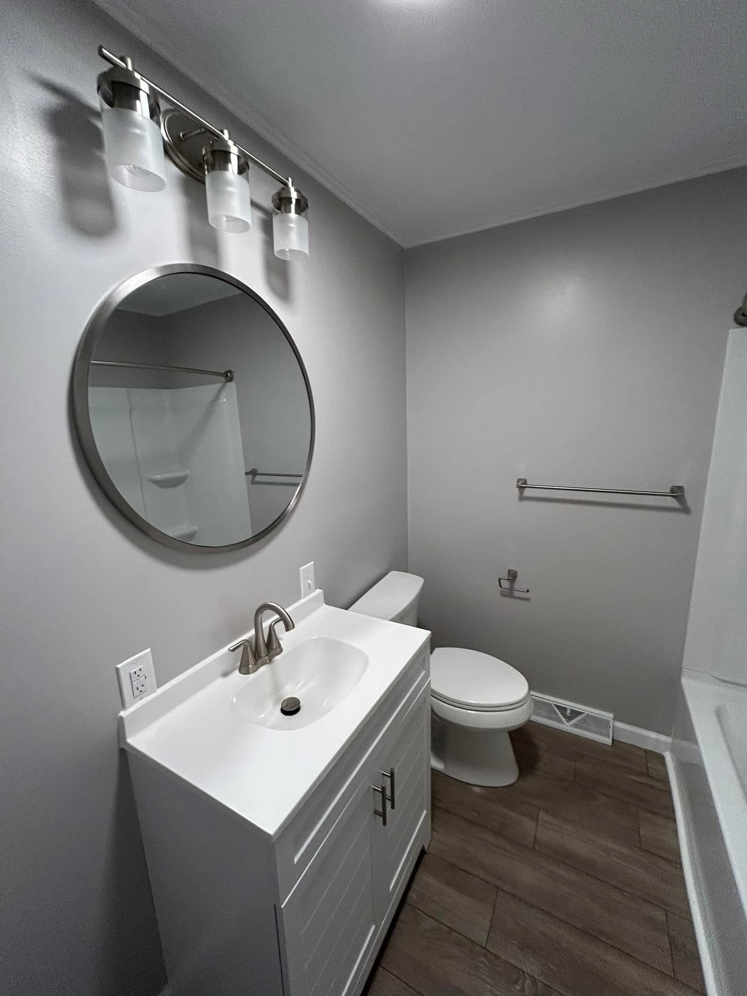 Gray Bath with Round Mirror