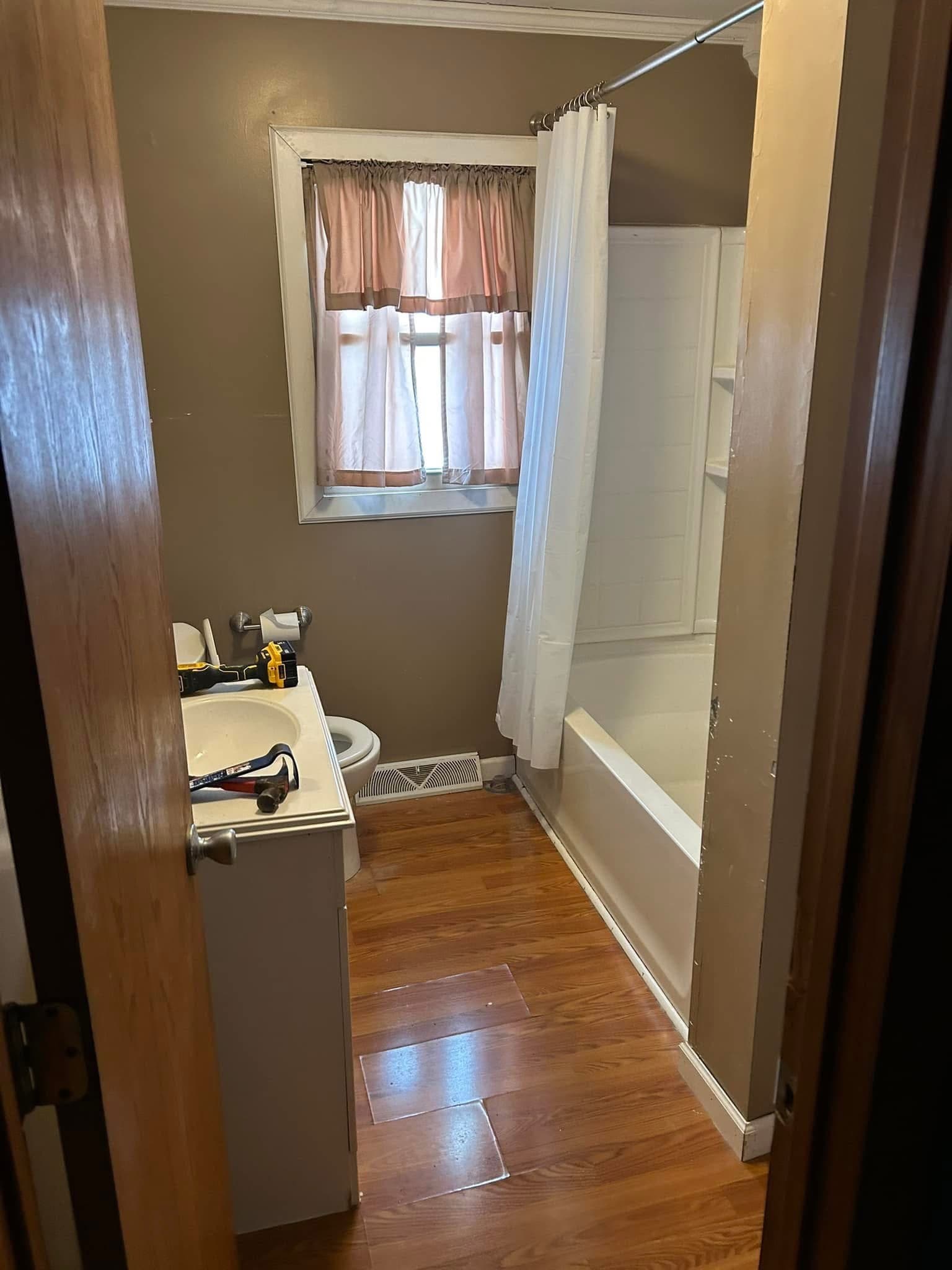 Before: Gray Bath with Round Mirror