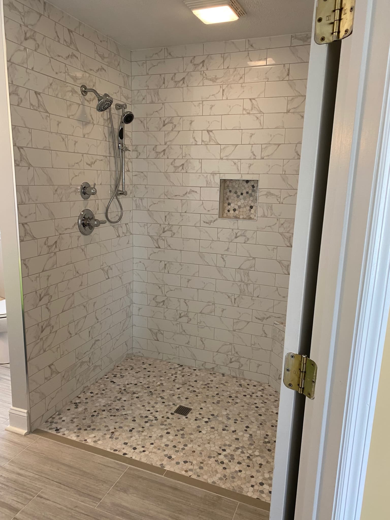 Marble Subway Shower with Pebble Floor